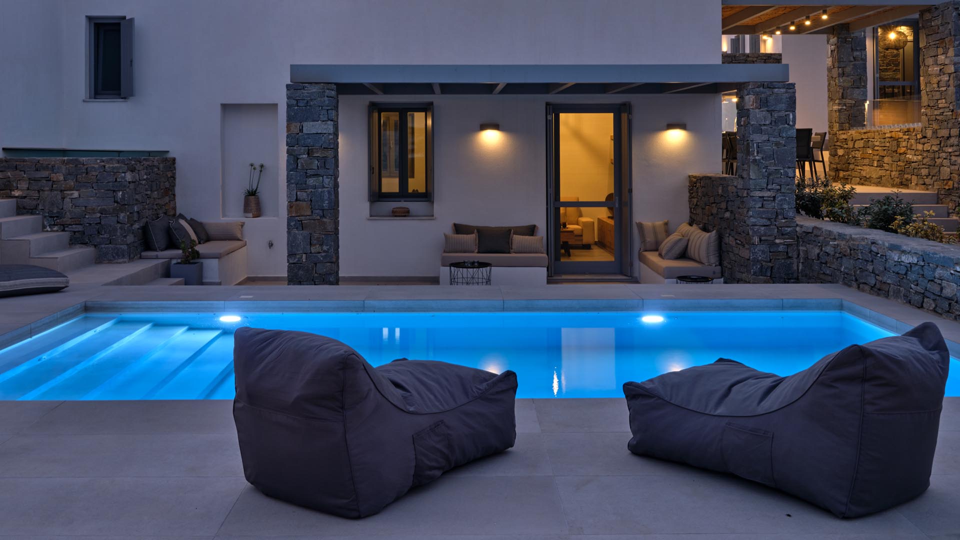 Outdoor pool nightime Ouranos